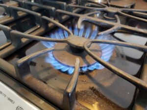 The main element of the image (gas stove burner) without mentioning potential negative aspects like pollution.